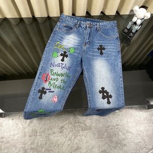 Chrome Hearts Distressed Blue Jeans with Black and Green Accents